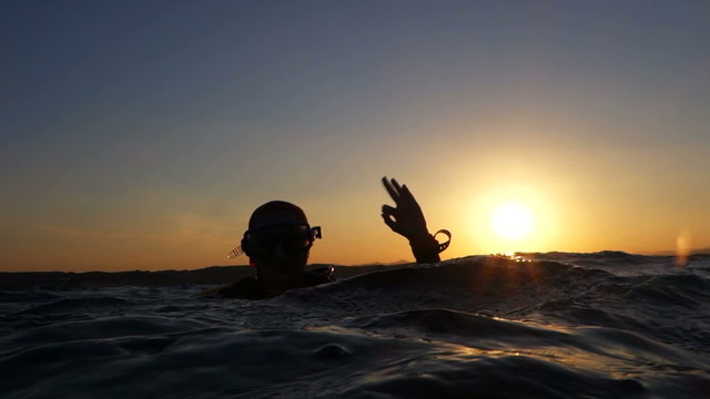 diver on the surface showing sign  ok
