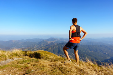 Hiker or runner looking at inspirational mountains landscape