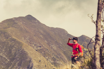 Fototapeta premium Hiking man or trail runner in mountains