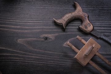 Rusty hand saw marking gauge on wooden board copy space