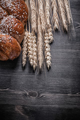 Bread golden wheat and rye ears on wooden board