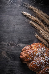 Bread golden wheat and rye ears on wooden board