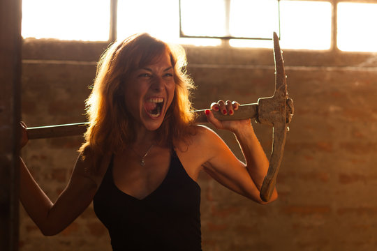 beautiful young woman posing with pickax