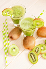 Naklejka na ściany i meble Fruit smoothie with fresh green kiwi on a wooden background