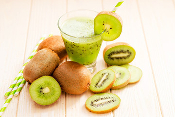 Fruit smoothie with fresh green kiwi on a wooden background