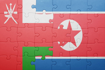 puzzle with the national flag of north korea and oman