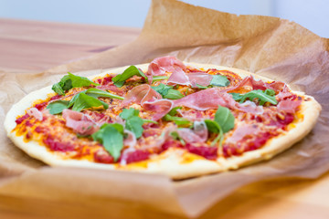 Italian style pizza with arugula and prosciutto