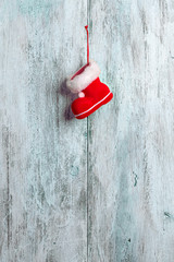 Red Santa's boot on the wooden background