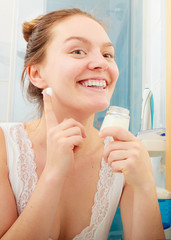 Woman applying moisturizing skin cream. Skincare.