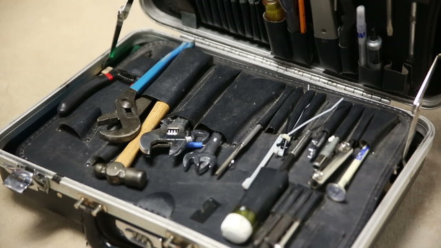 Tool Case Tilt Down. camera tilts down on an old case filled with work tools. close up.
