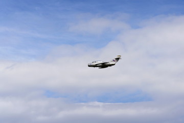 Jet fighter aircraft Mikoyan-Gurevich MiG-15 flying with dramatic clouds