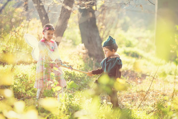 Cute little fairy and a knight playing in the nature