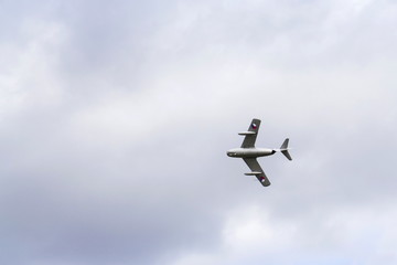 Jet fighter aircraft Mikoyan-Gurevich MiG-15 flying with dramatic clouds