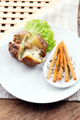 Baked potatoes with cheese and mushrooms on table close up