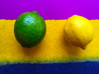 Two citrus fruits on a purple, yellow and blue textured background
