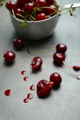 Cherries in bowl, on wooden background