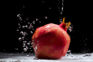 Pomegranate splashing water