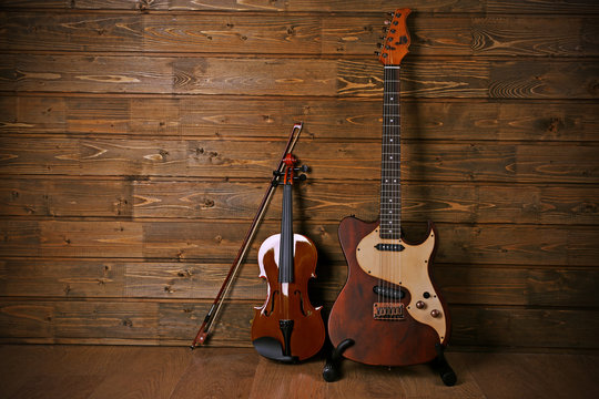 Electric and violin on wooden background