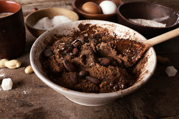 Preparing dough for chocolate pie on table close up