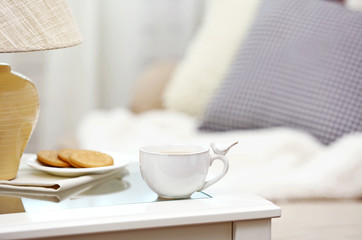 Cup of coffee on table in living room