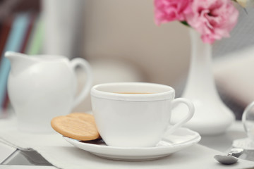 Fototapeta na wymiar Cup of coffee on table in living room
