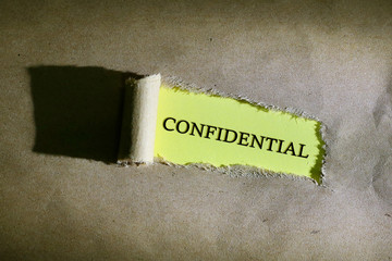 Torn paper with word confidential
