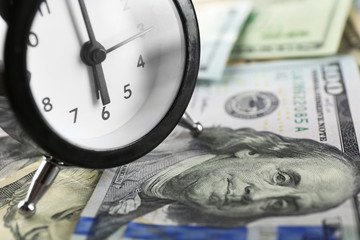 Money and alarm clock, closeup