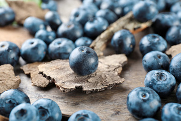 Tasty ripe blueberries on wooden table close up