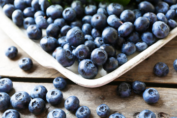 Tasty ripe blueberries on wooden table close up