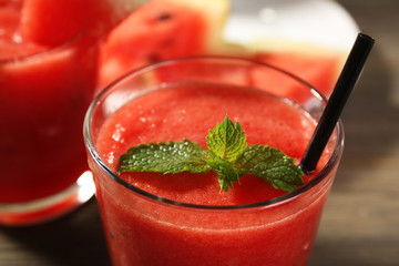 Glasses of watermelon juice on wooden table, closeup
