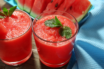 Glasses of watermelon juice on wooden table, closeup