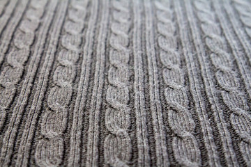 Many cables on gray cable knit fabric, full frame