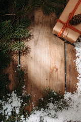  gift box and fur tree on wooden background