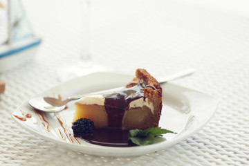 Delicious cake under chocolate glaze with blackberry and mint
