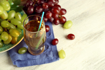 Glass with grape juice on blue napkin
