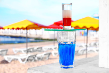 Alcohol cocktails on beach bar counter, close up