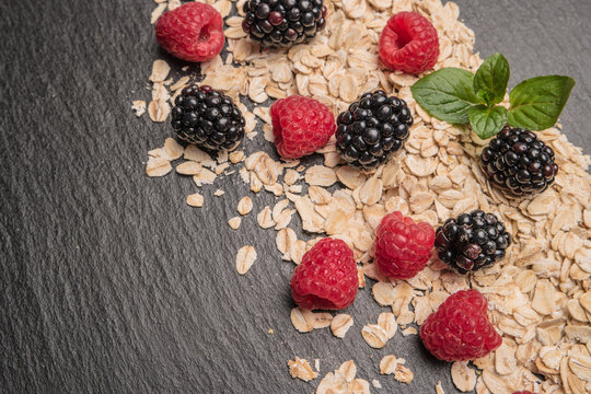 Healthy breakfast and berries on slate background, close-up