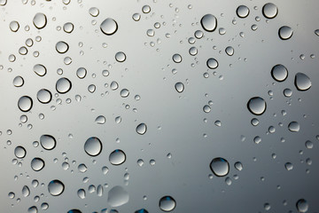 closeup water drop on glass mirror background.