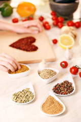 Variety of spices in ceramic containers on the kitchen table