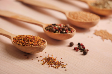 Variety of spices in spoons on the kitchen table