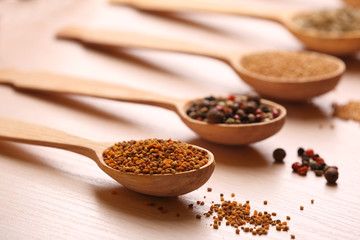 Variety of spices in spoons on the kitchen table