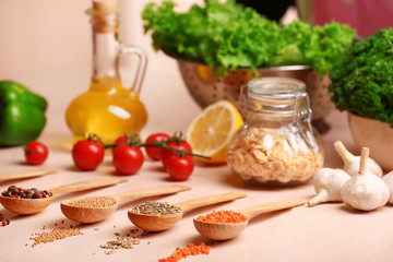 Variety of spices in spoons on the kitchen table