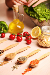 Variety of spices in spoons on the kitchen table