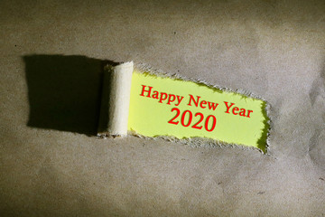 Torn paper with word Happy New Year 2020