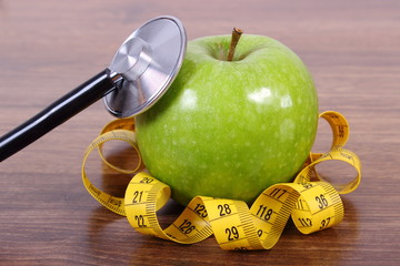 Stethoscope, fresh apple and centimeter, healthy lifestyles and nutrition