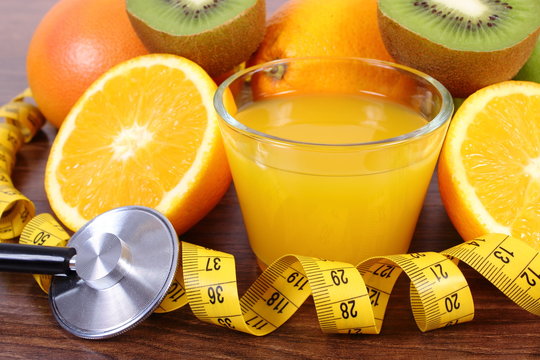Stethoscope, fresh fruits, juice and centimeter, healthy lifestyles and nutrition