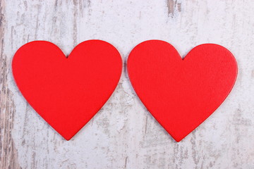 Valentine red hearts on old wooden white table, symbol of love