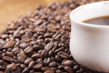 Coffee cup and coffee beans on table