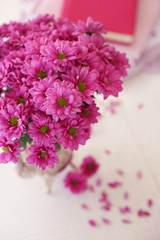 Beautiful flowers in vase on table in room
