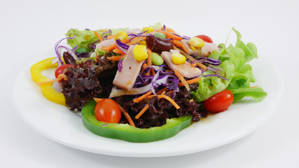 The vegetable and ham salad on the white dish.